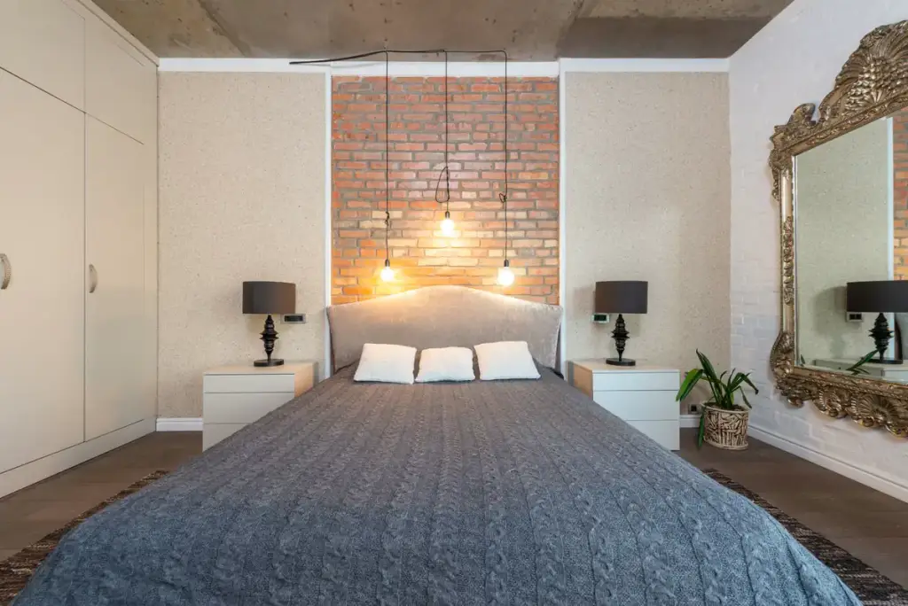 Bedroom with a brick wall