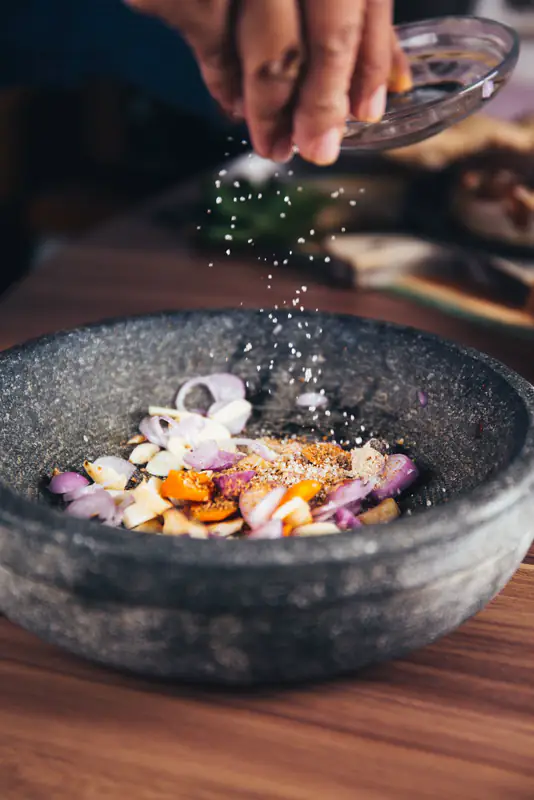 Chef seasoning a dish
