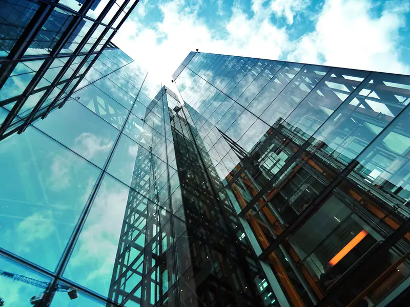 Glass tower against blue sky