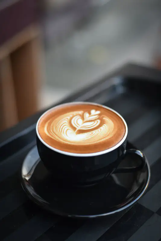 Latte art in black cup