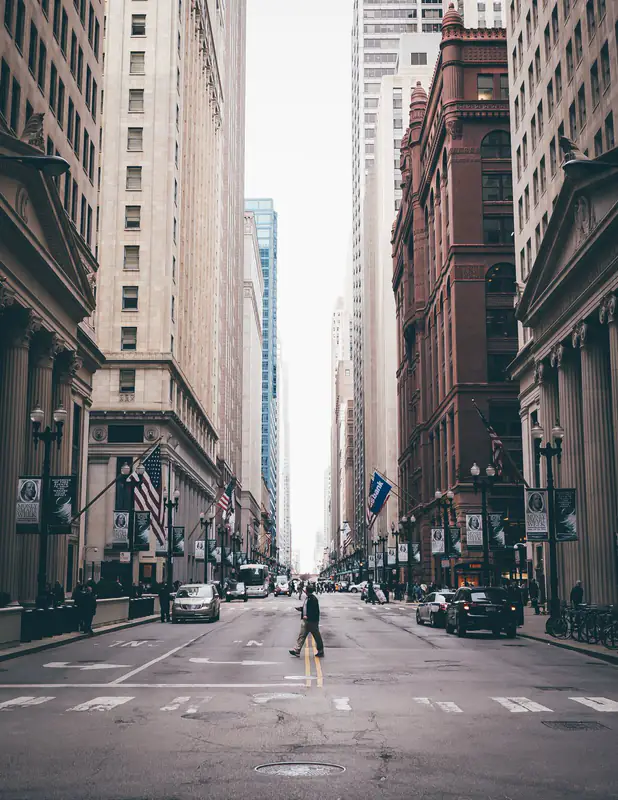Pedestrian between tall buildings