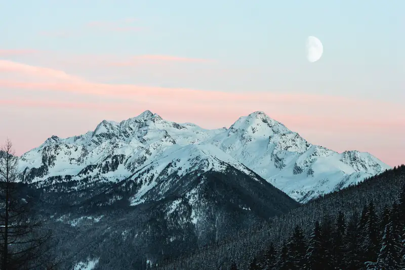 Snowy peaks under pastel sky