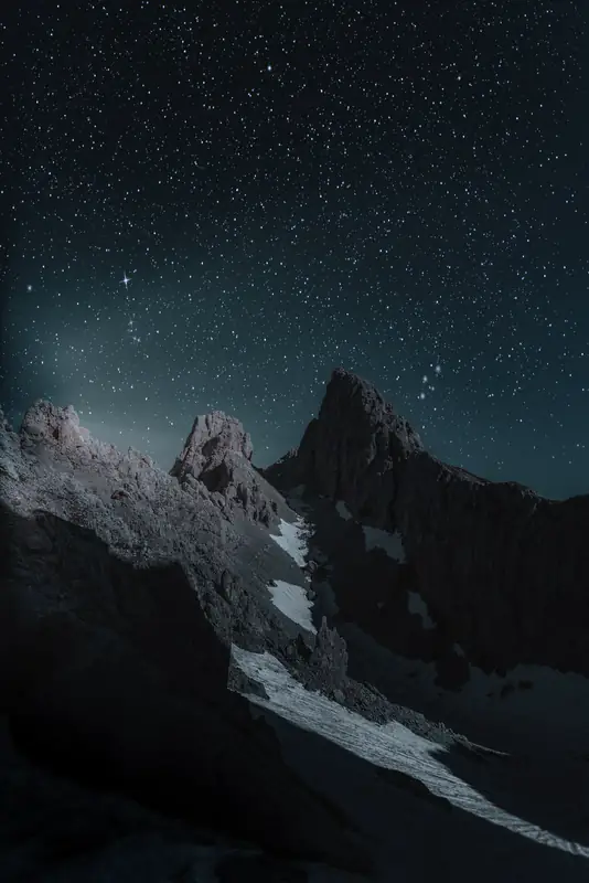 Starry sky over dark peak