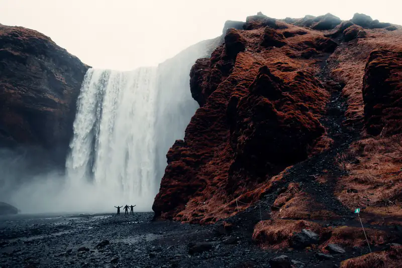 Waterfall beside red cliffs