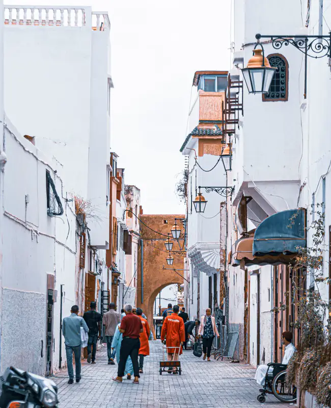 Whitewashed alley with walkers