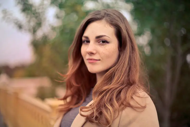 Woman with auburn hair outdoors